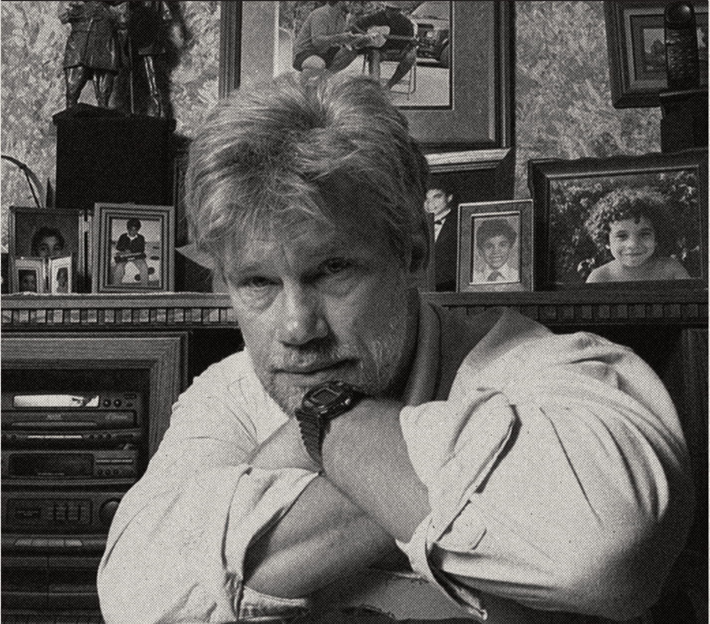 Mike Hedges at home surrounded by family photographs