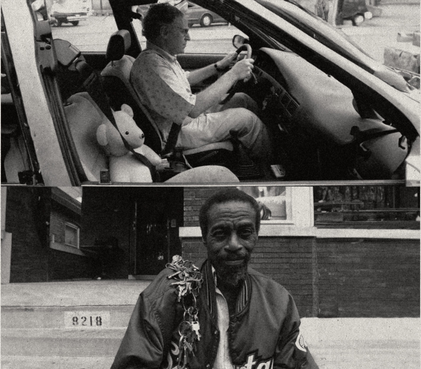 A man driving a car, and a man on a Chicago sidewalk